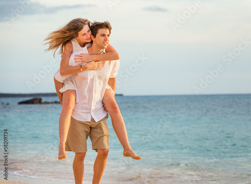 Romantic happy couple on the beach at sunset  man and woman in l