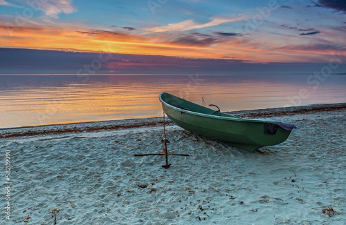 Fototapeta Naklejka Na Ścianę i Meble -  Lonely fishing boat at a sandy beach of the Baltic Sea
