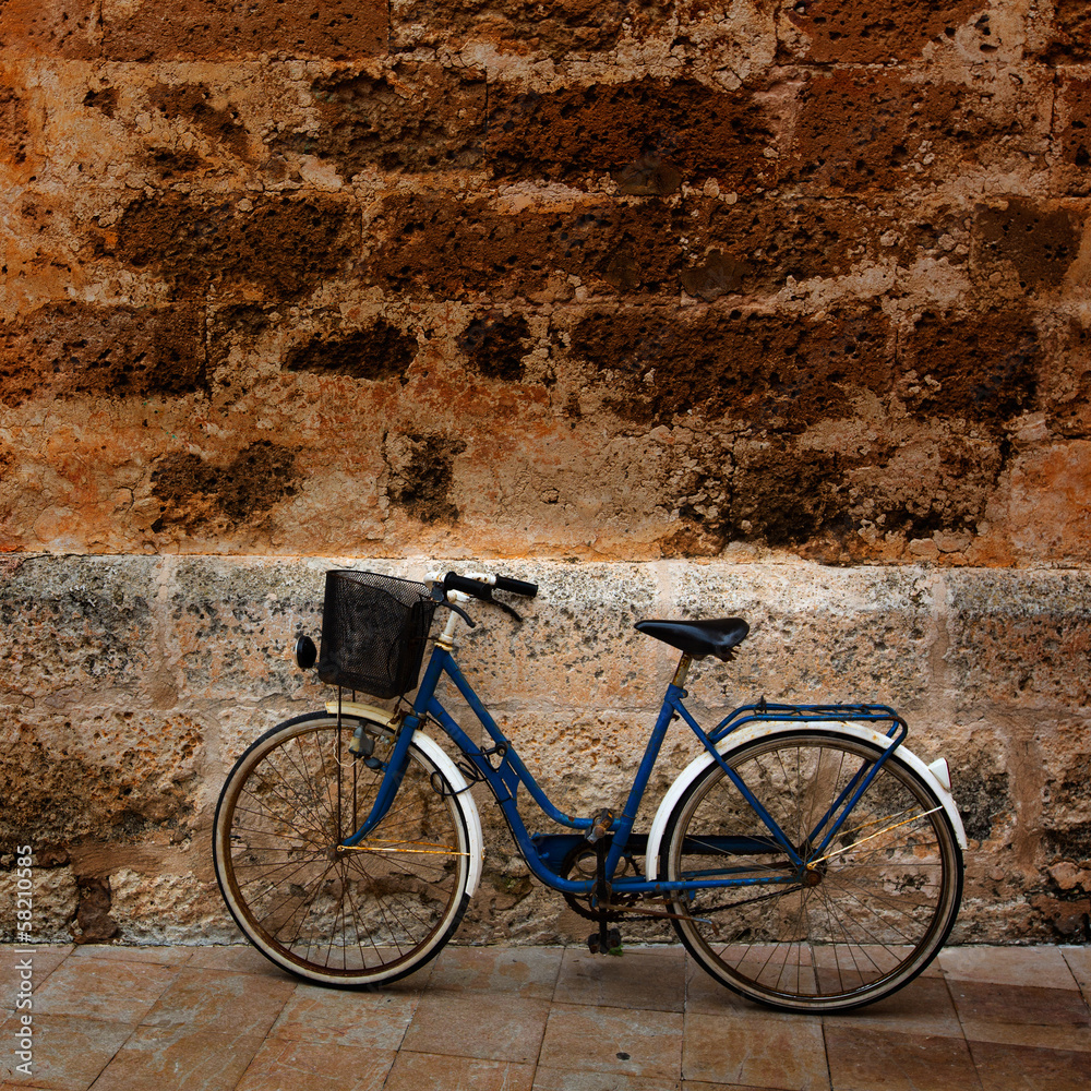 Bicycle in historical Ciutadella stone wall at Balearics