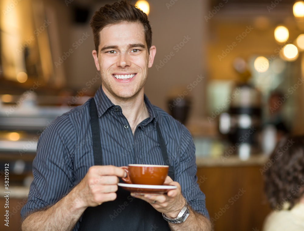 Happy Waiter Holding Coffee Cup In Cafeteria Happy Waiter Holding Coffee Cup In Cafeteria