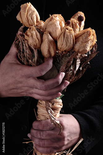 hands dirty and dried roses