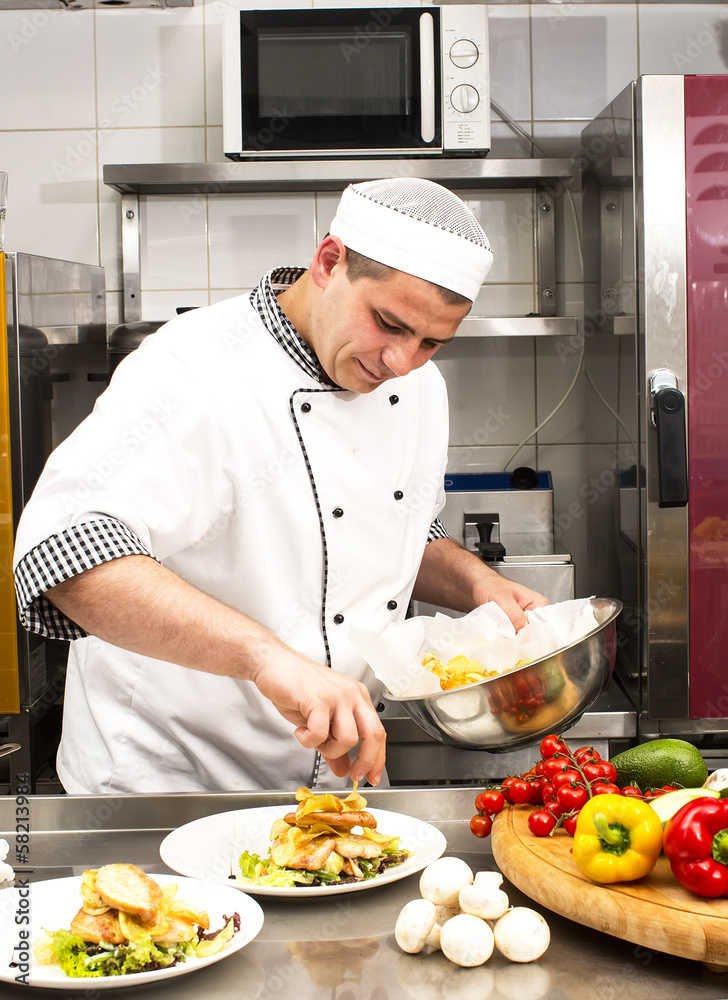 chef preparing food in the kitchen at the restaurant chef preparing food in the kitchen at the restaurant
