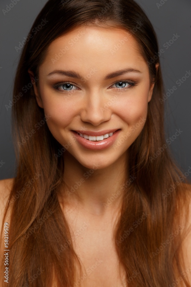 Beautiful young brunette woman with blue eyes