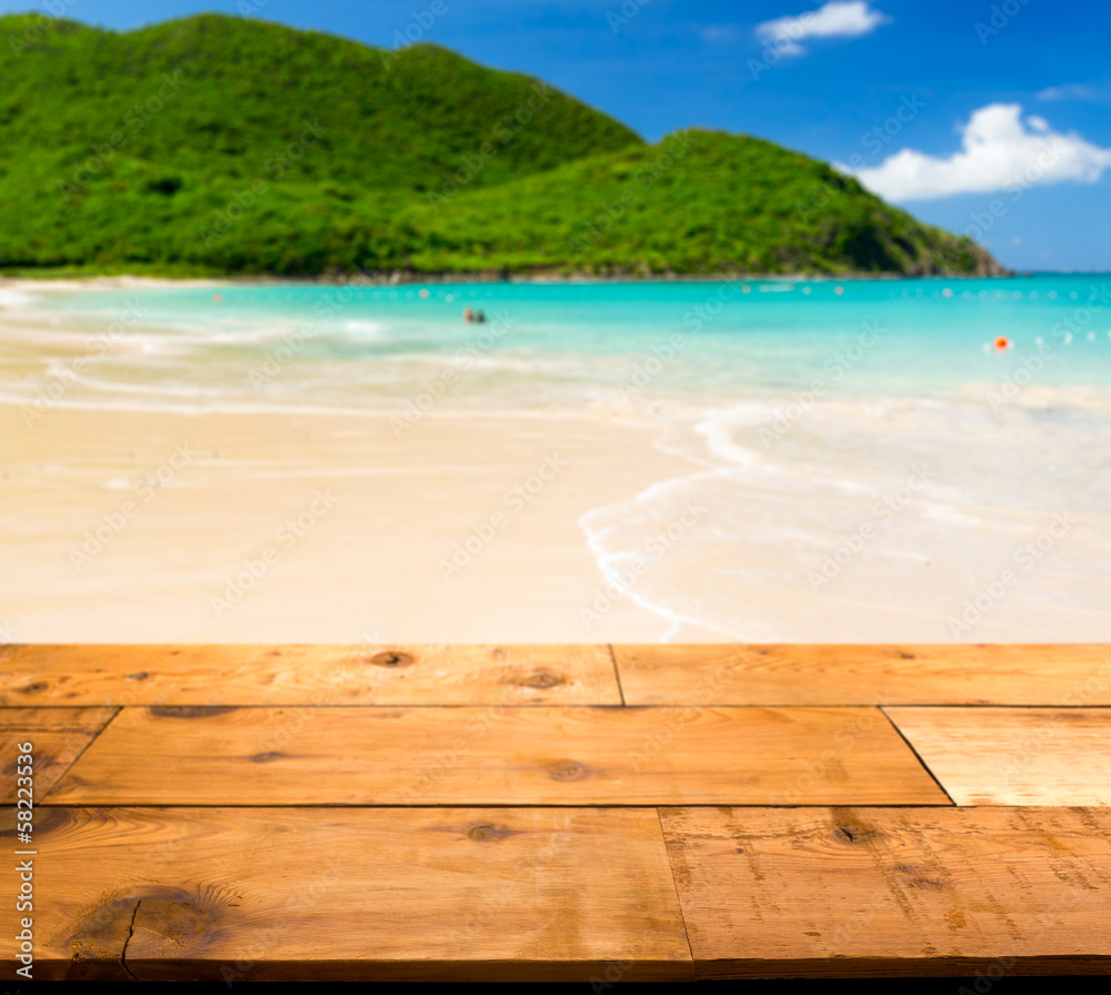 Warm sandy beach in caribbean by wooden decking