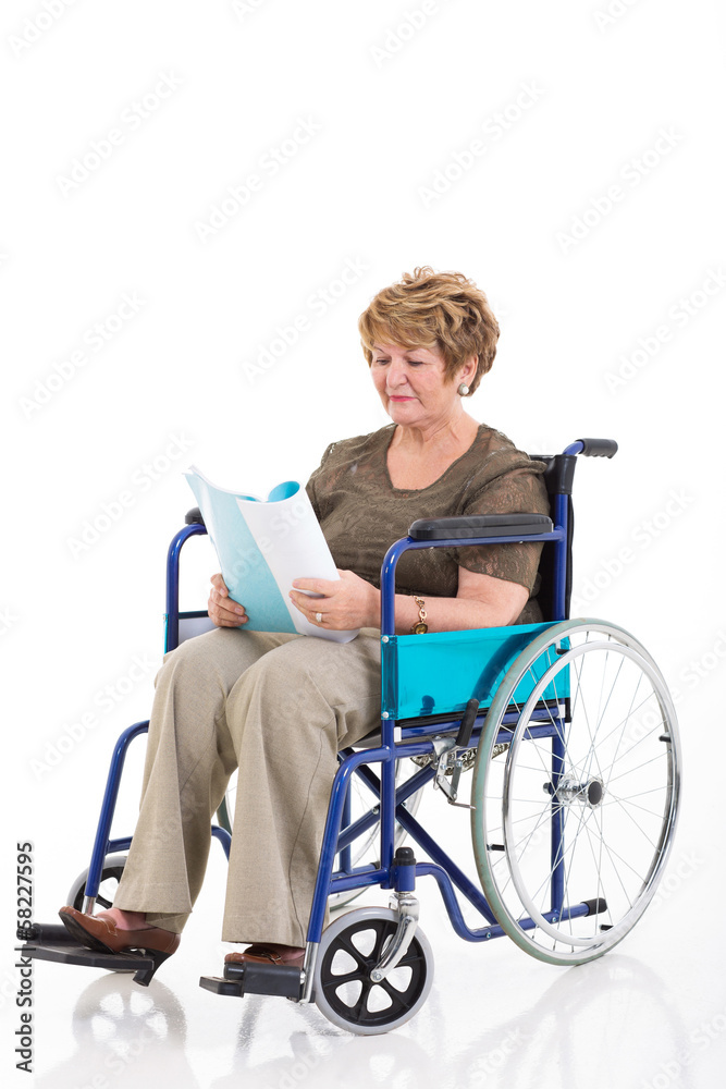 disabled senior woman reading a book on wheelchair disabled senior woman reading a book on wheelchair