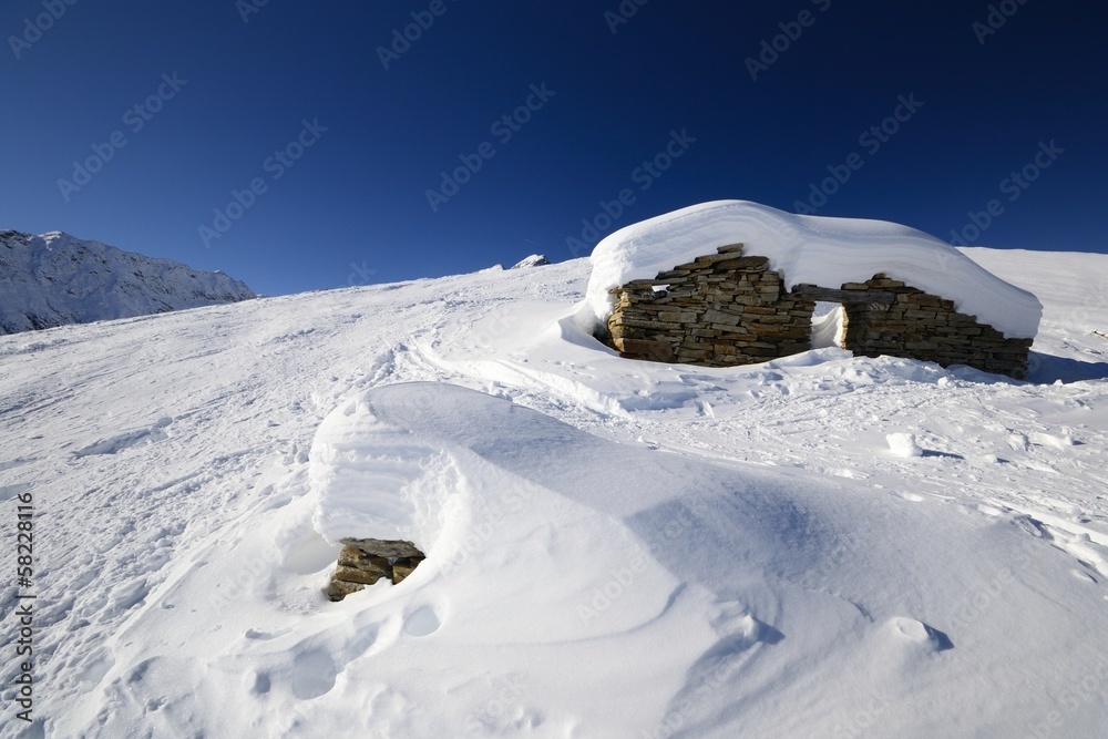 Ruins of an old pasture hut in winter
