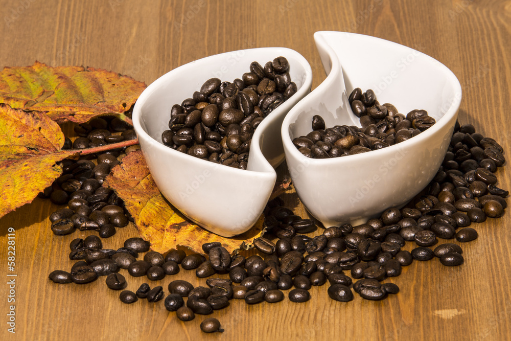 cups with coffee beans on a wooden table cups with coffee beans on a wooden table