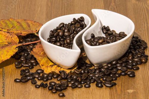 cups with coffee beans on a wooden table