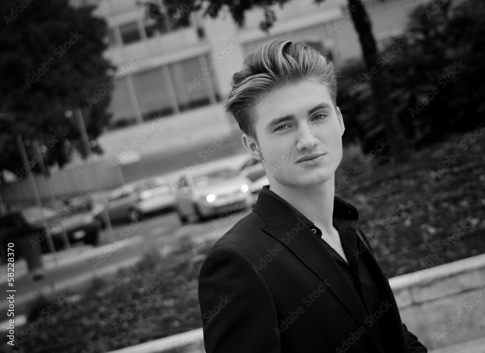 Attractive blue eyed, blond young man outdoors in city Attractive blue eyed, blond young man outdoors in city