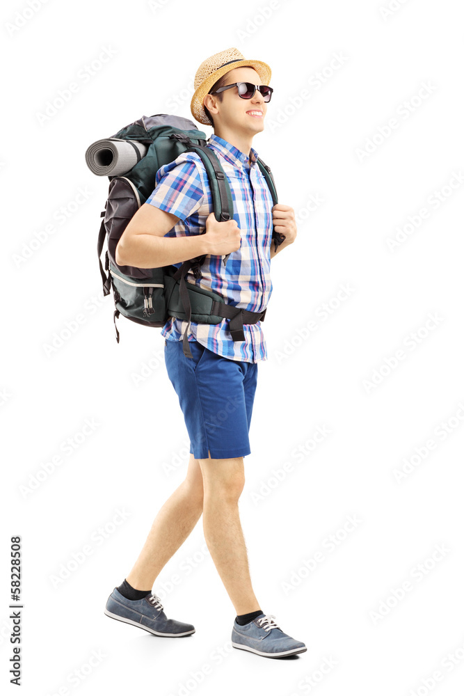 Full length portrait of a male hiker with backpack walking