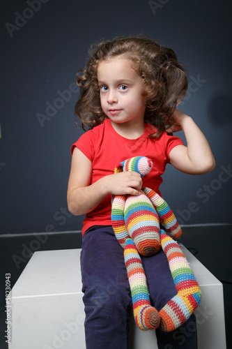 Portrait of a girl with a toy