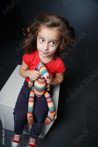 Portrait of a girl with a toy
