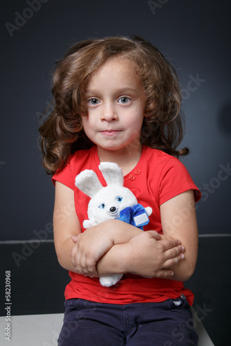 Portrait of a girl with a toy