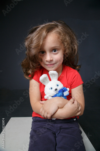Portrait of a girl with a toy