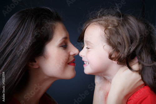 Mother touches noses with her daughter