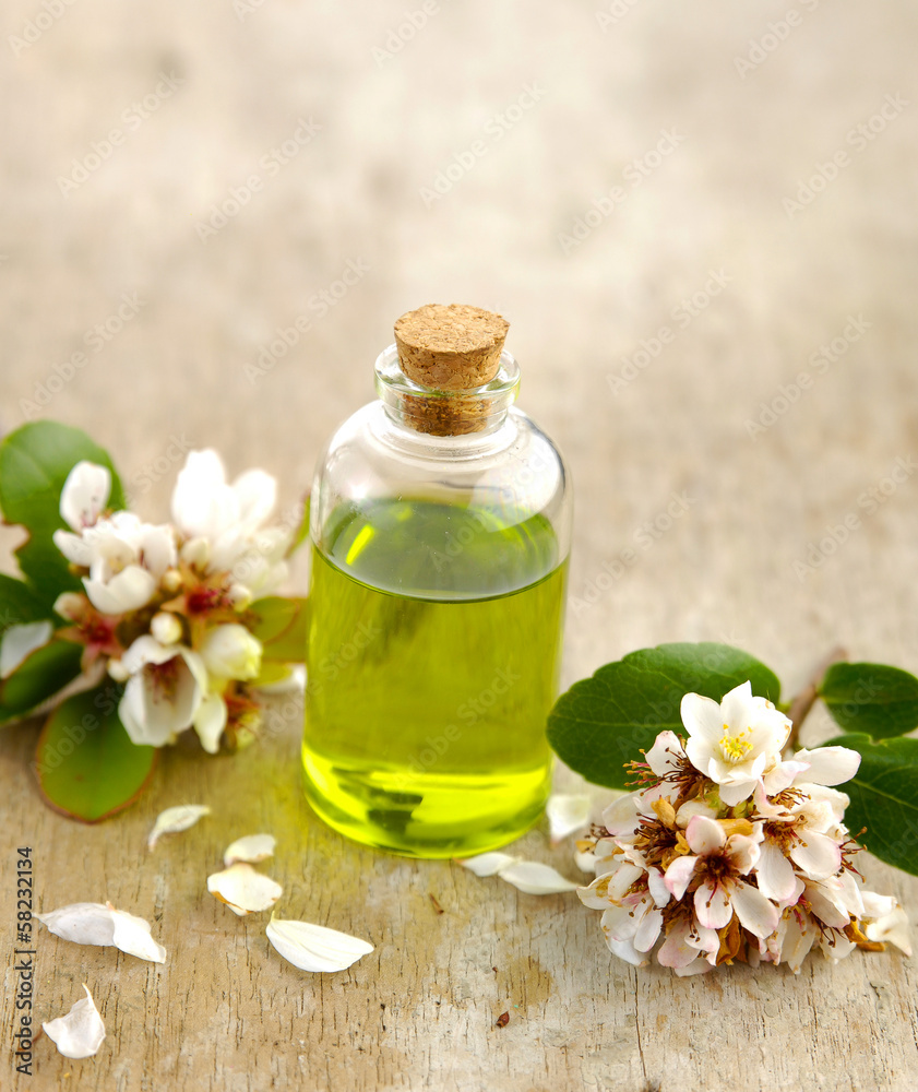 spring flower with massage oil on old wooden spring flower with massage oil on old wooden
