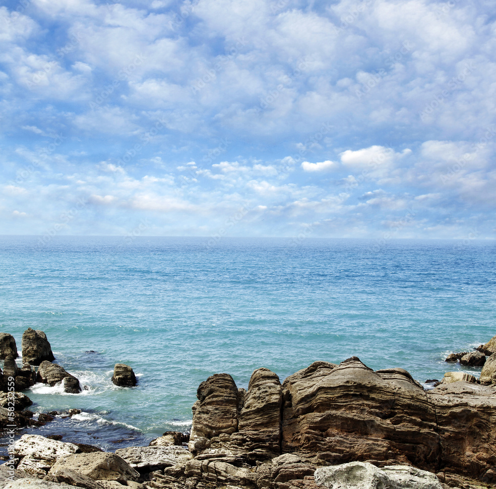 Shoreline rocks, sea and sky