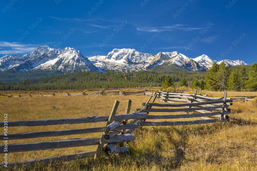 Idaho mountain range and log fence with snow