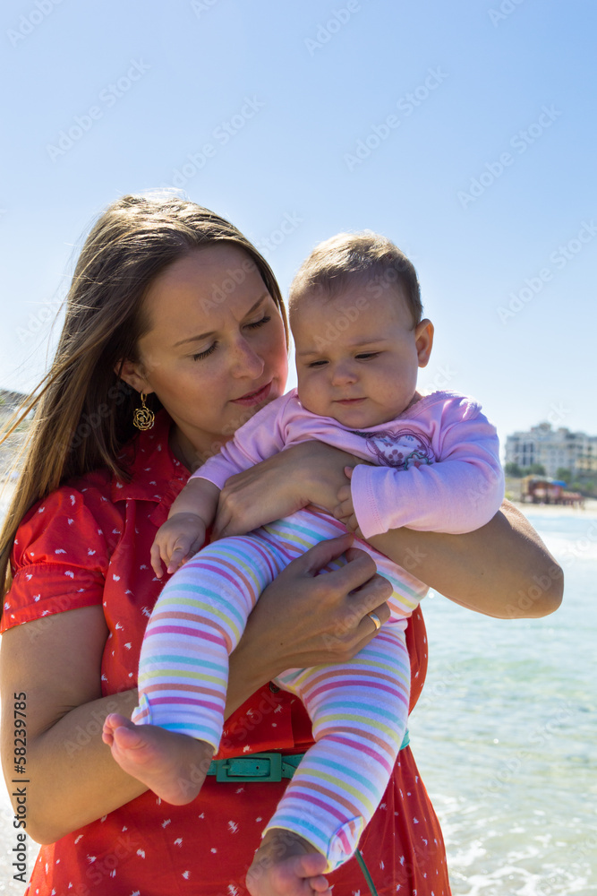 Mother and cute little baby girl on the beach Mother and cute little baby girl on the beach
