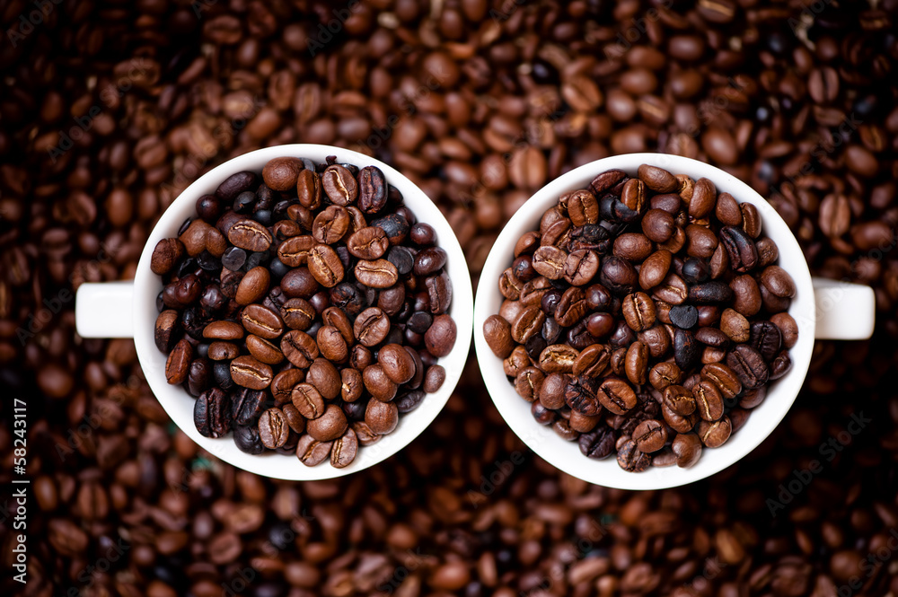 Detail of white cups of coffee filled with coffee beans