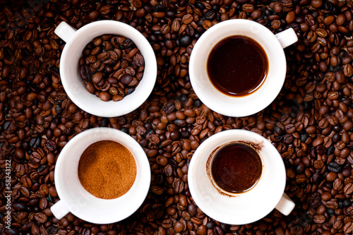 Four different mugs of coffee, ground, coffee beans