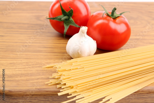 Spaghetti and tomatoes on board.