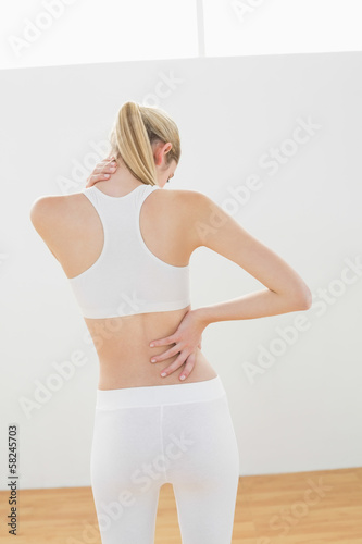Quadro su tela Sporty blonde woman touching her injured nape