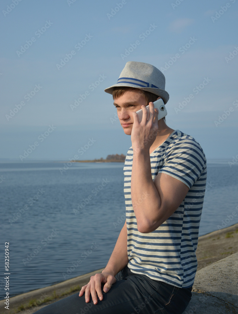 Young man speaking on a cell phone.