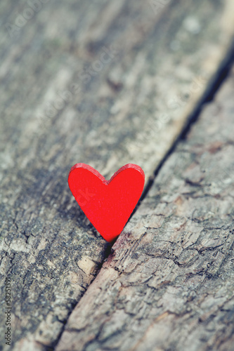 red hearts on rustic wooden surface