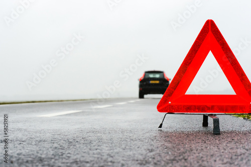 car with a breakdown in the rain and fog