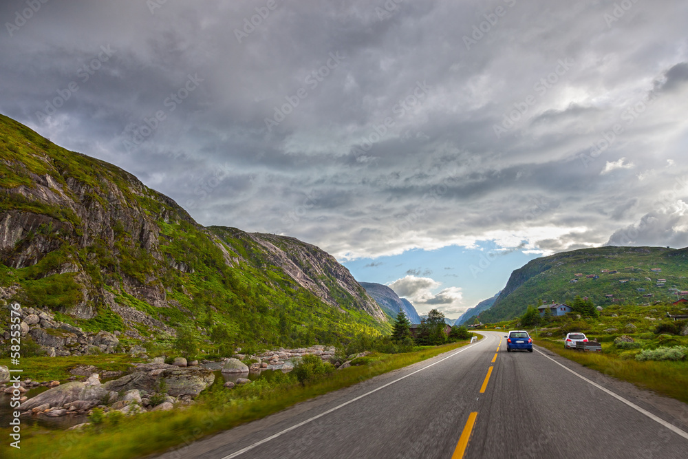 Mountain road and dramatic sky in Norway.