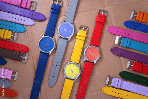 composition of colourful watches on cardboard background