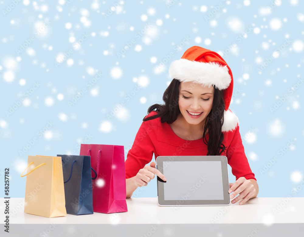 woman in santa helper hat with tablet pc woman in santa helper hat with tablet pc