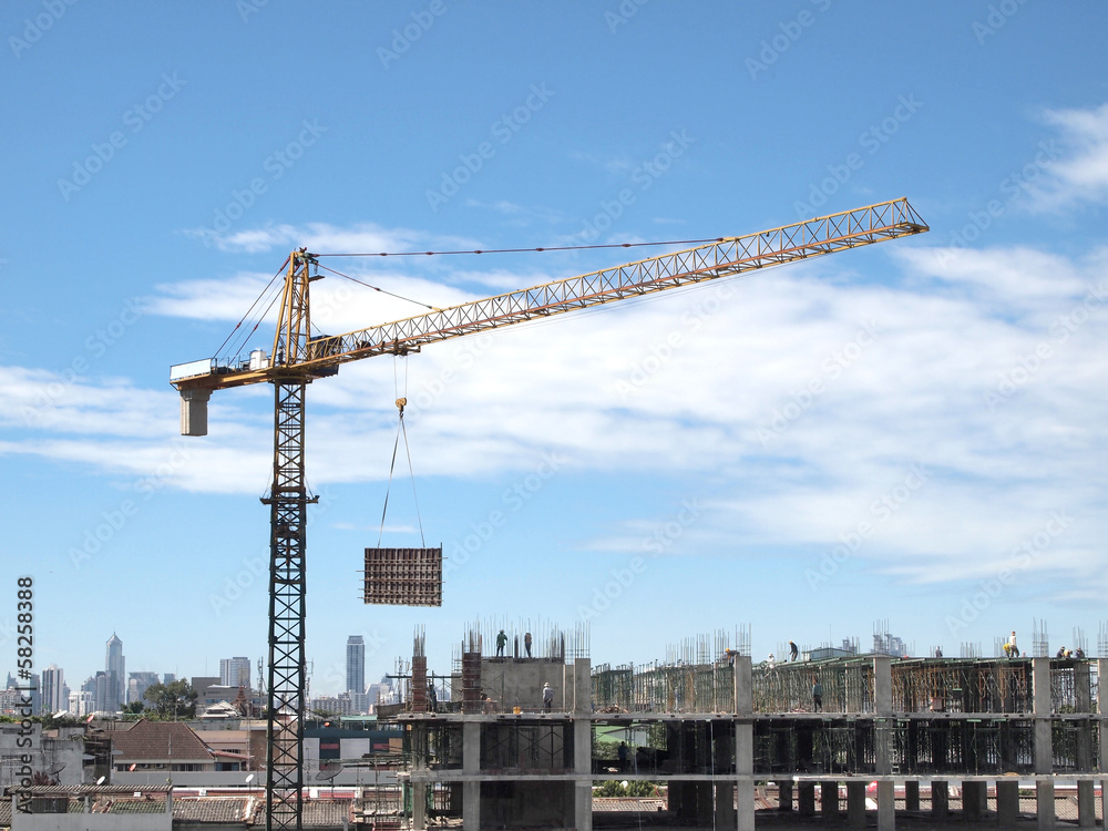 Industrial landscape with cranes on the blue sky