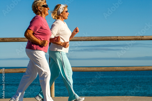 golden girls jogging along beachfront.