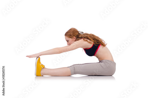 Young sporty woman doing exercises on white