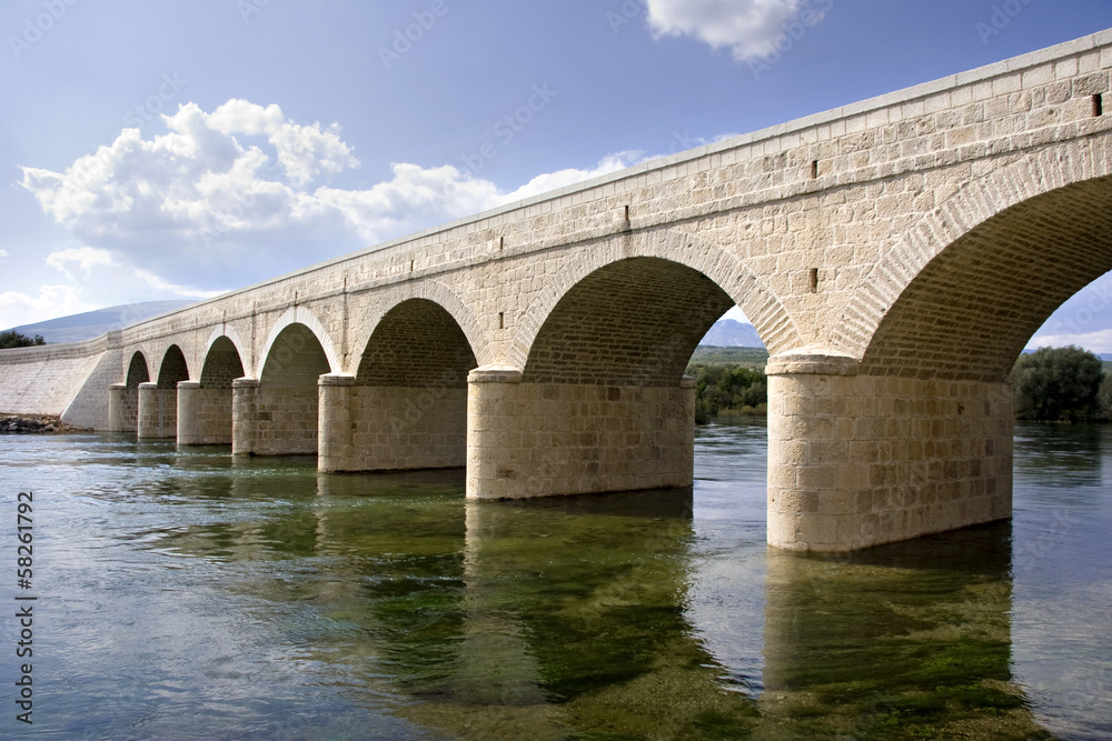 Ancient stone arch bridge over the river Cetina in Croatia