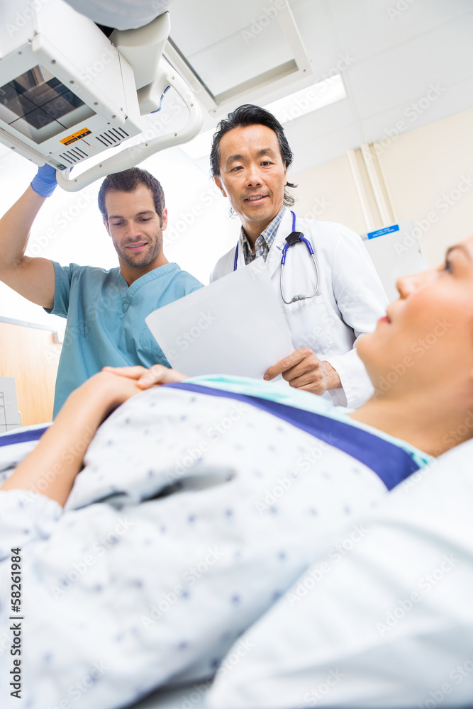 Medical Team Preparing Patient In Xray Room Medical Team Preparing Patient In Xray Room