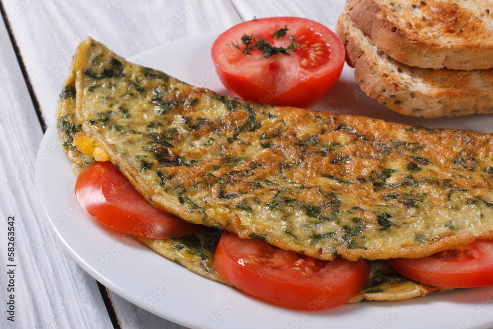 An omelet with spinach and tomatoes. Healthy and tasty breakfast