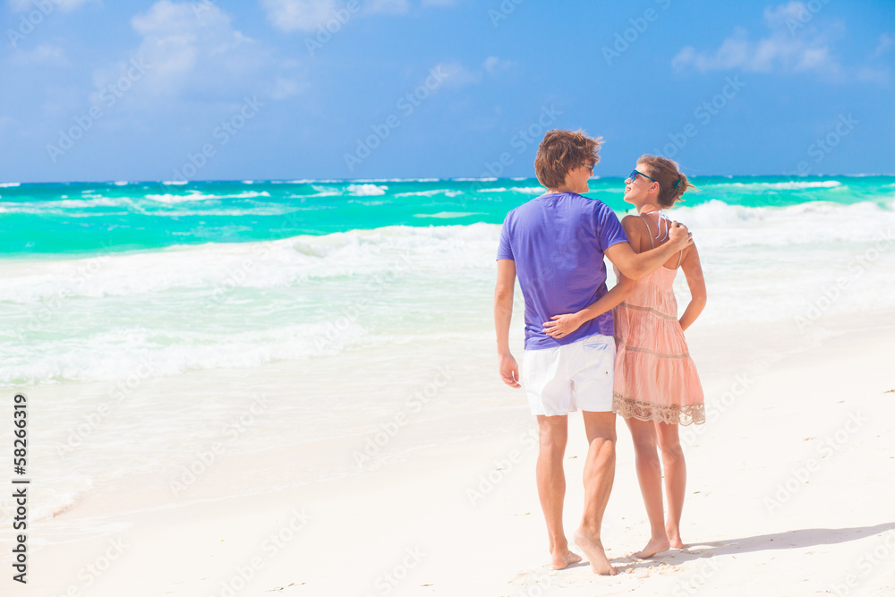 Couple walking and having fun on a tropical beach Couple walking and having fun on a tropical beach
