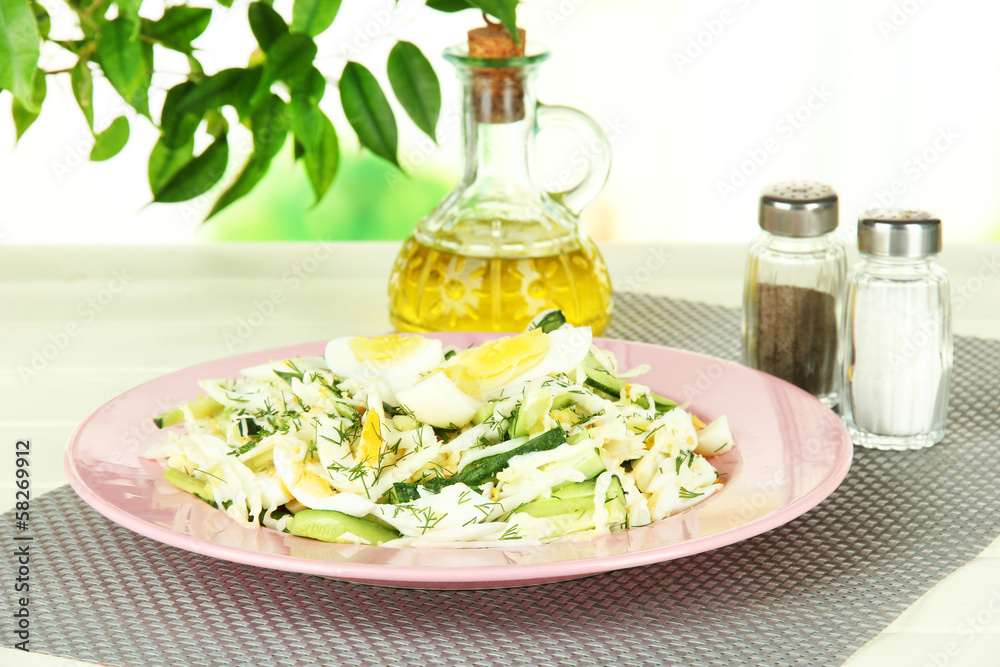 Delicious salad with eggs, cabbage and cucumbers on table Delicious salad with eggs, cabbage and cucumbers on table