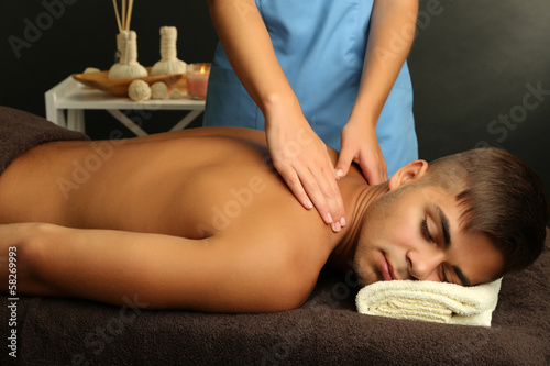 Young man having back massage close up