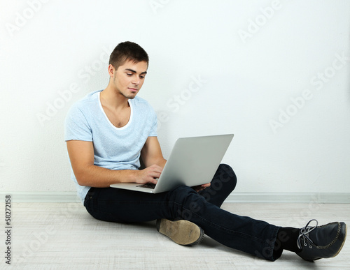 Guy sitting on floor in room