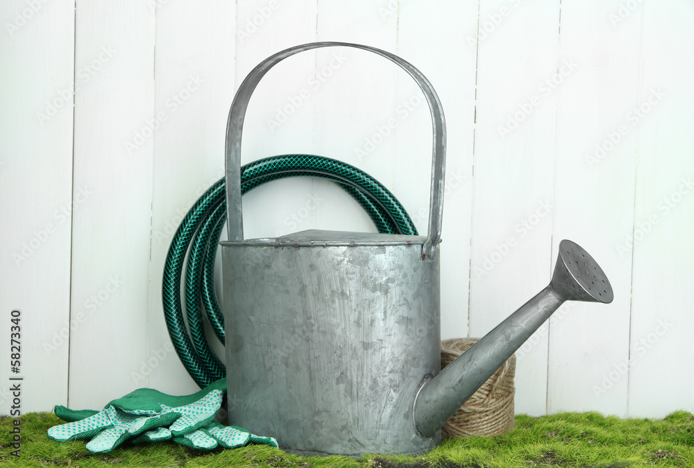 Gardening tools on grass on wooden background Gardening tools on grass on wooden background