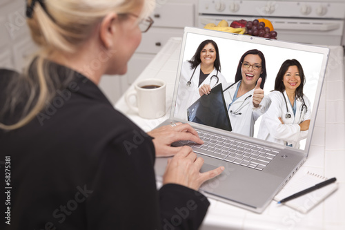 Woman Using Laptop Viewing ...