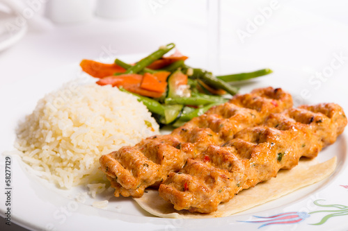 Chicken Adana Kebap Served with Rice Pilaf Vegetables and Red Vi