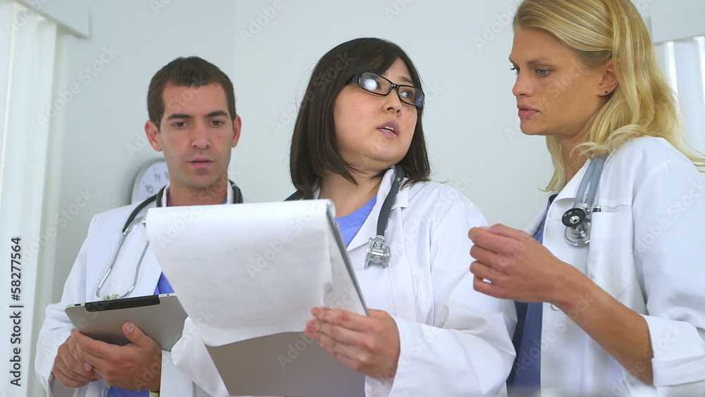Team of highly skilled doctors reviewing patient's health proble Team of highly skilled doctors reviewing patient's health proble