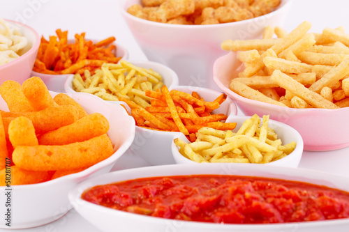 Potato, corn and wheat chips in bowls photo