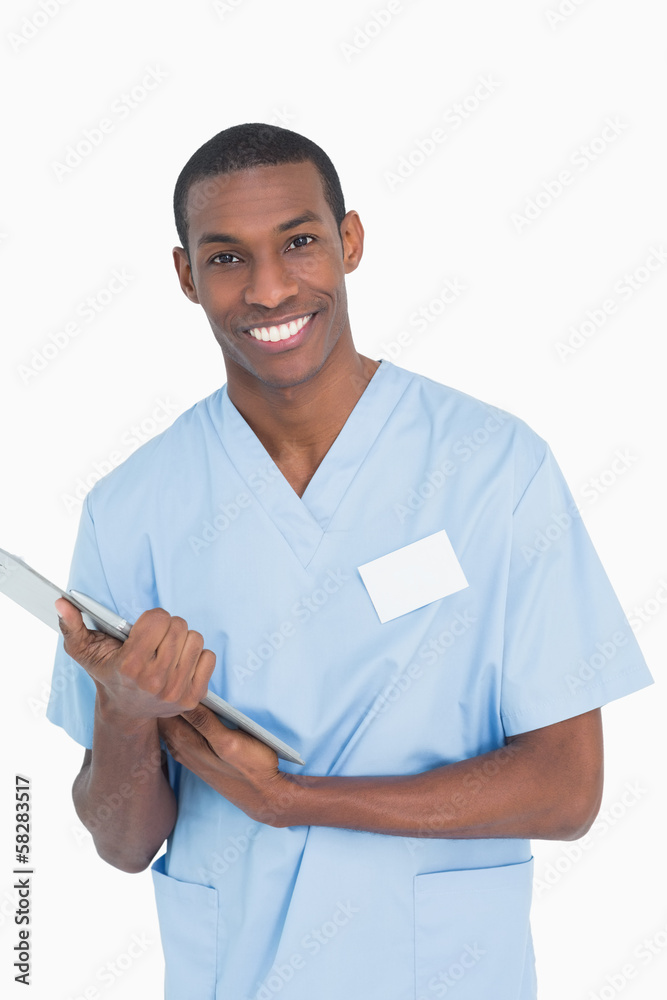 Portrait of a smiling male surgeon with clipboard Portrait of a smiling male surgeon with clipboard