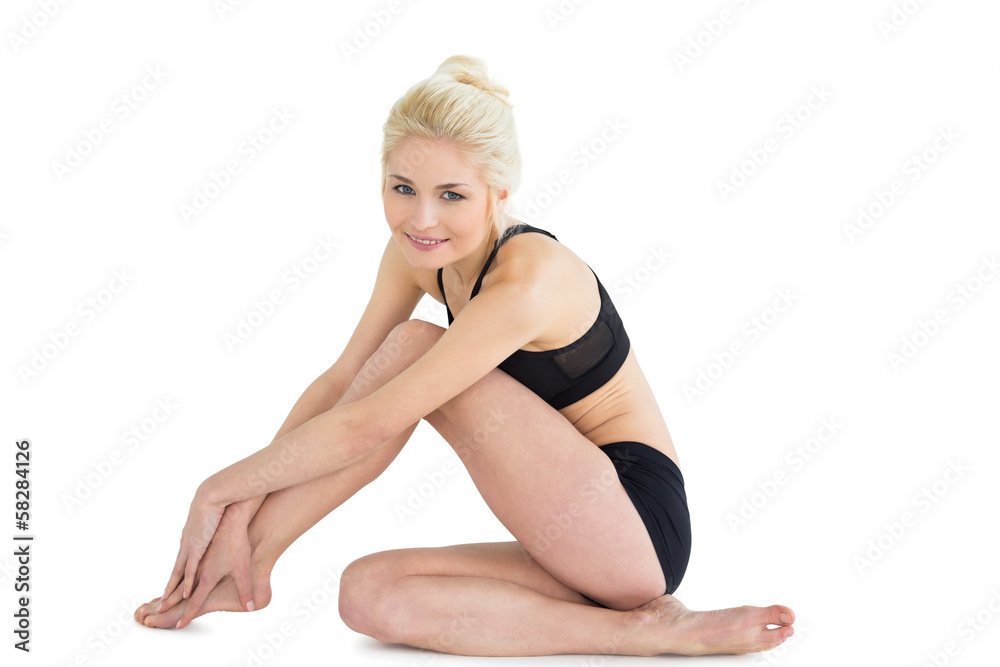 Toned woman sitting over white background Toned woman sitting over white background